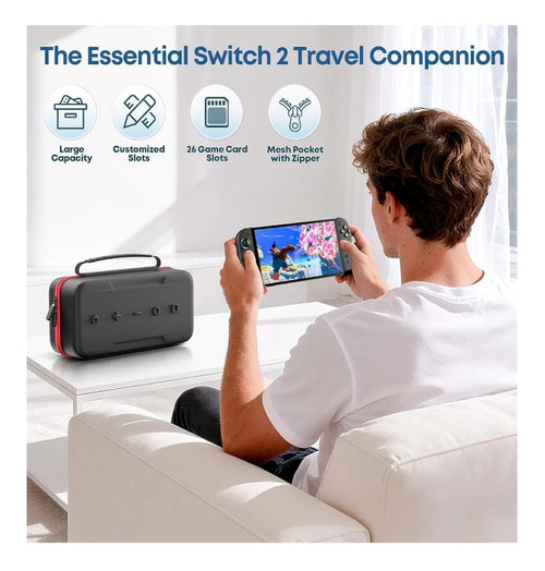 Black Switch 2 carrying case with carry handle on a sofa beside a person playing a Nintendo Switch 2